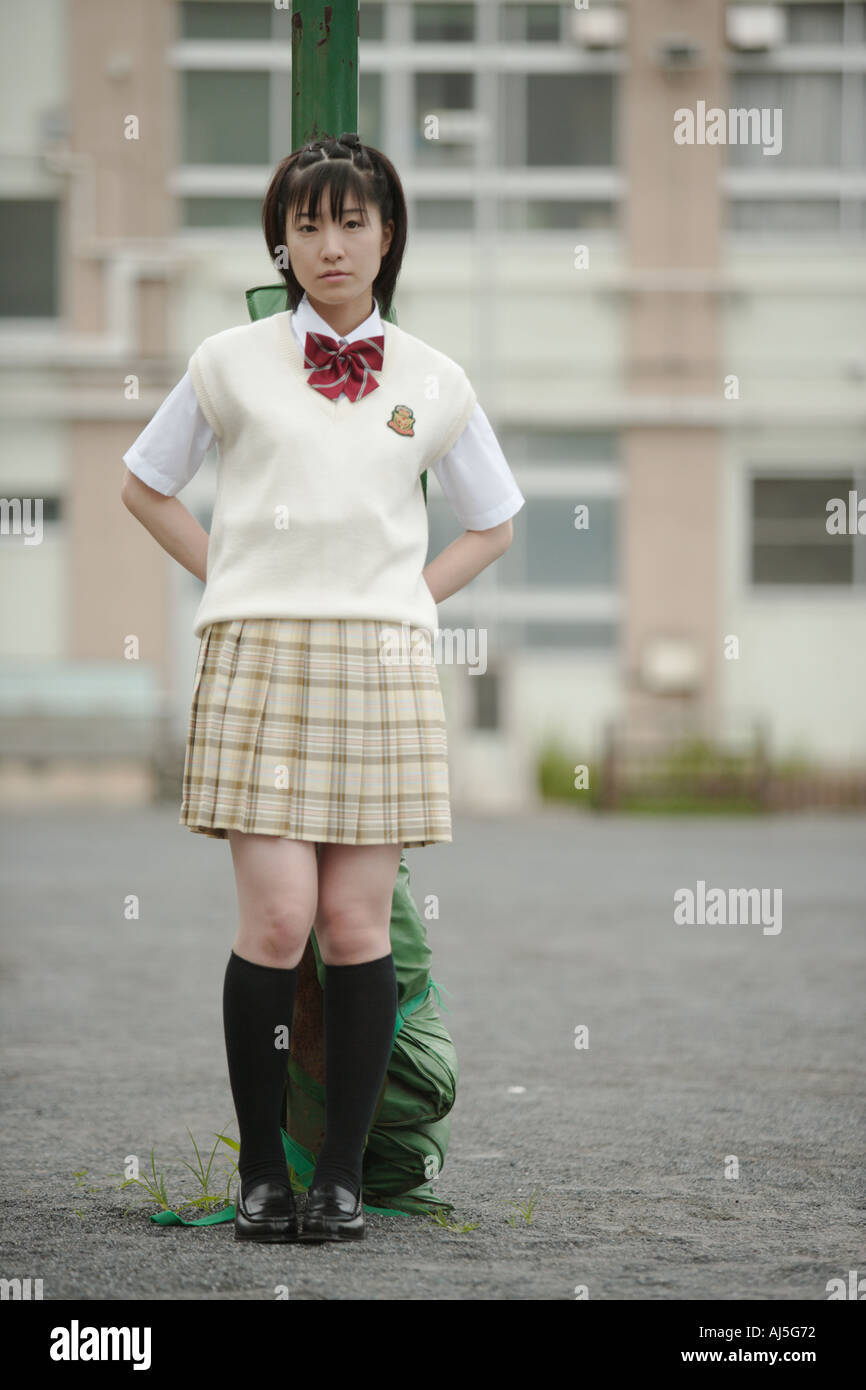 High school girl standing in schoolyard Stock Photo - Alamy