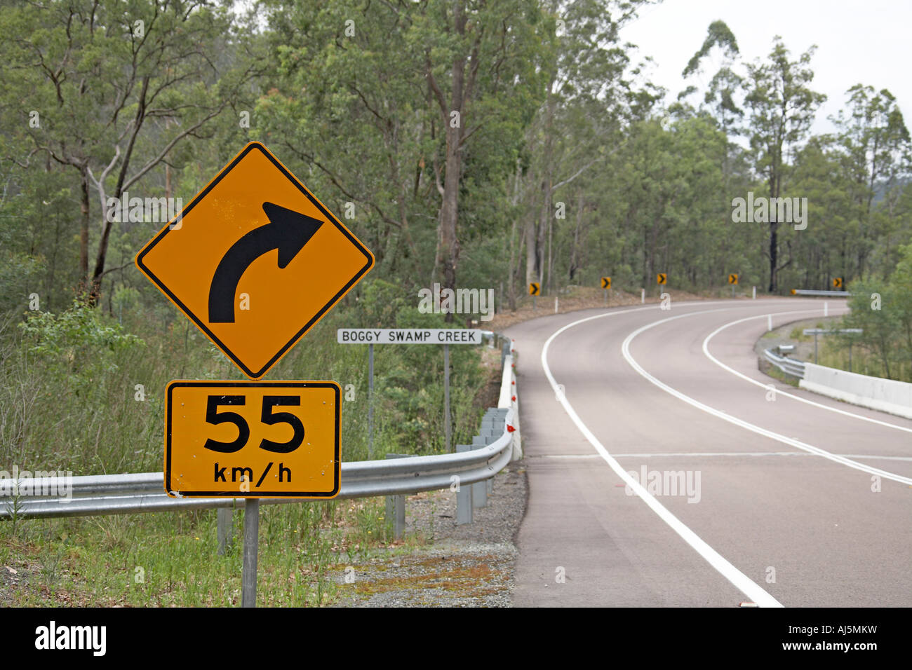 55 km h speed limit and bend sign by road in Blue Mountains New South Wales NSW Australia Stock Photo