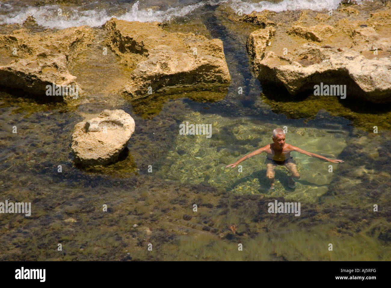 Elderly man bathing at the beach pool Stock Photo Alamy