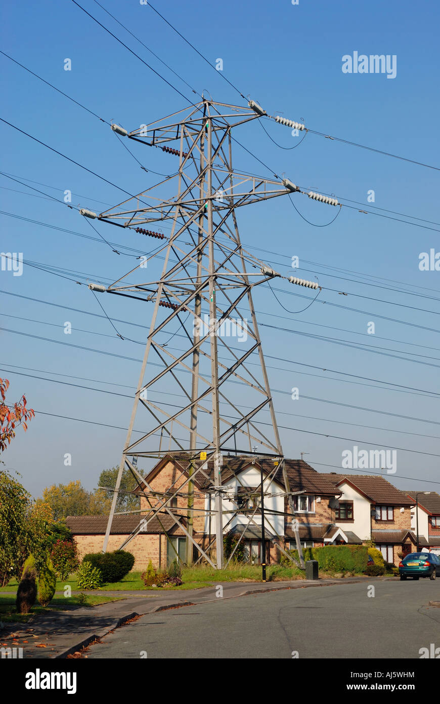 Electricity pylon built next to house on residential estate in Stock