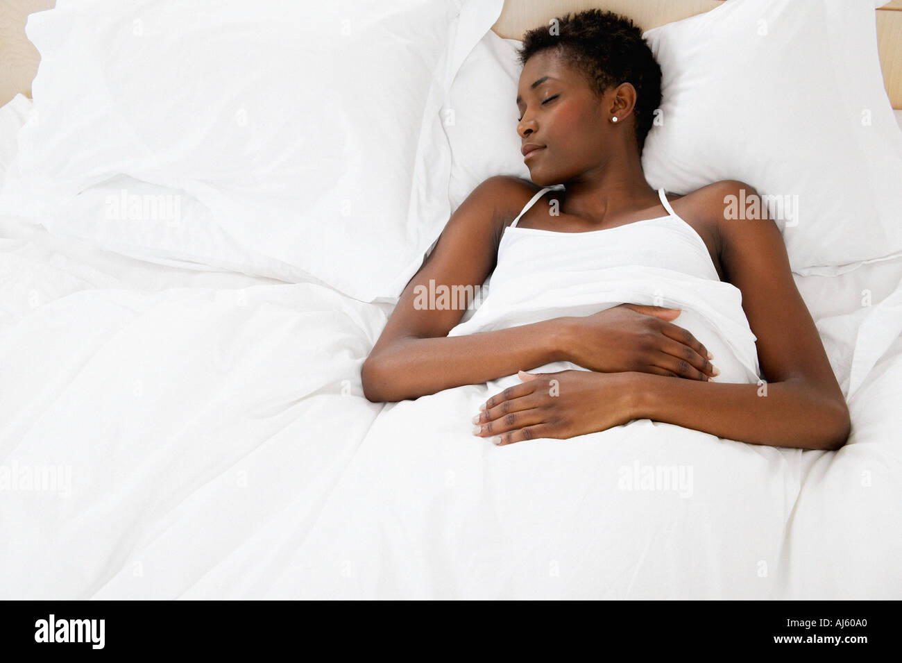 Woman resting in bed Stock Photo