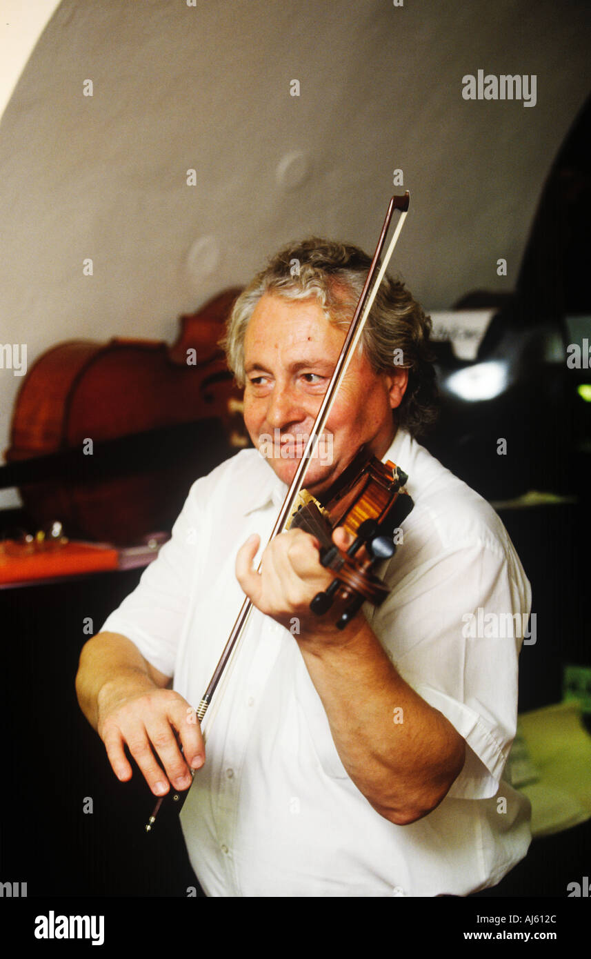 A music shop owner playing in Prague Czech Republic Stock Photo