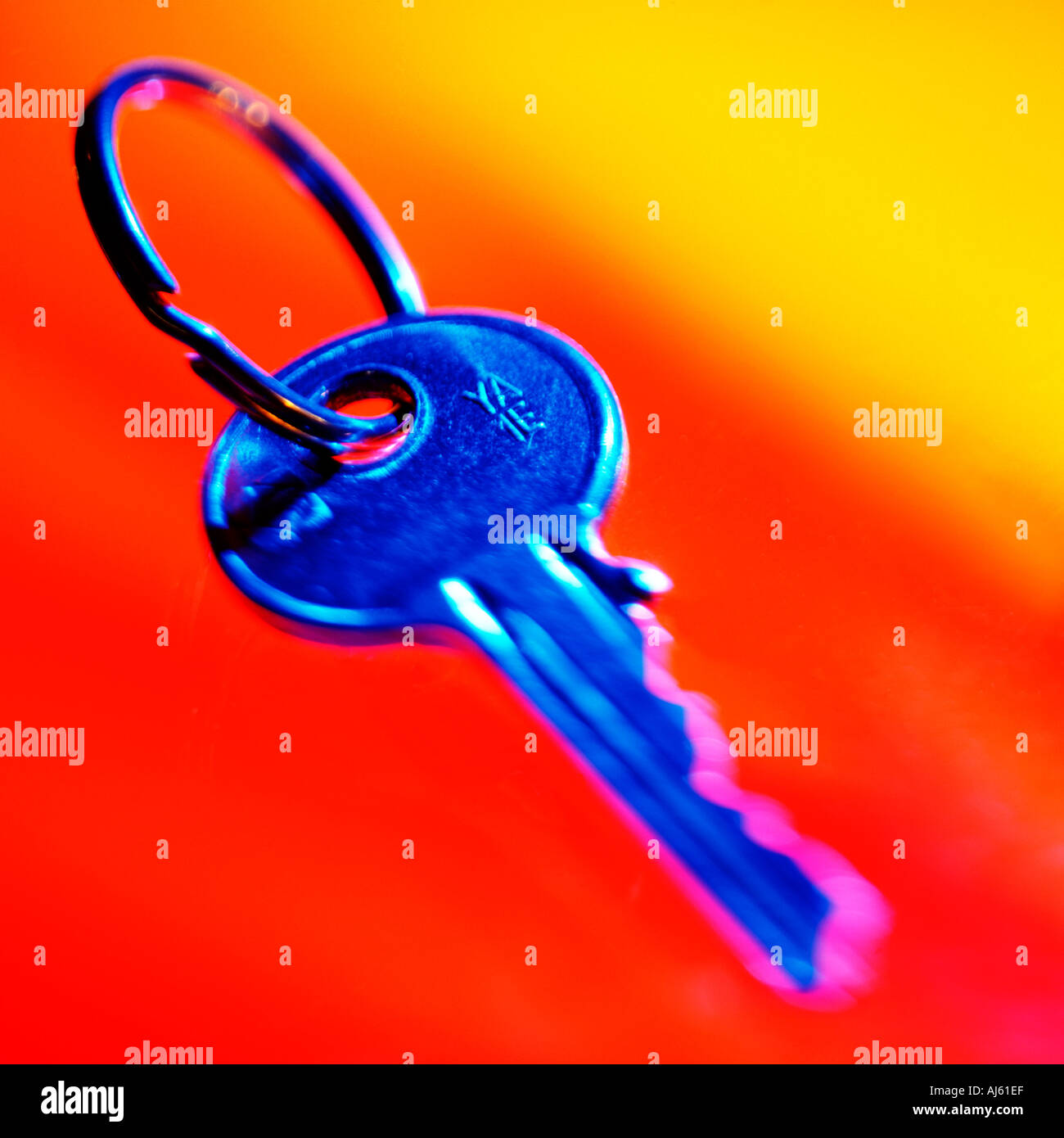 Blue latch key on orange and yellow background Stock Photo Alamy