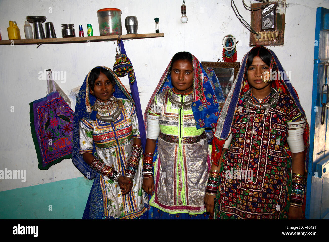 Two pretty Harijan tribal girls beside married woman wearing large nose ring in Ludia Village, nr Khavda, Kutch district, Gujarat, India Stock Photo