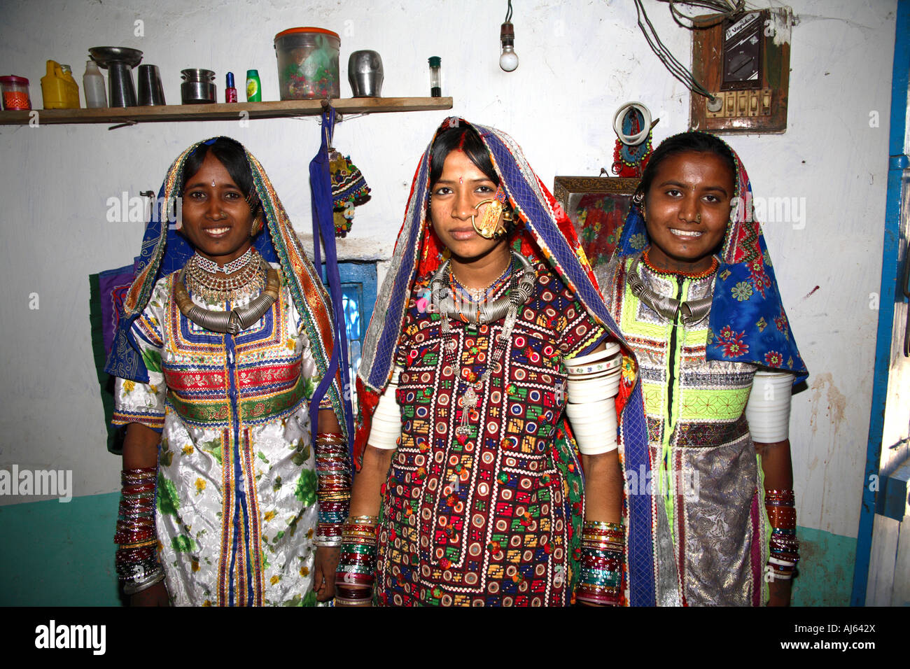 Two pretty Harijan tribal girls either side of married female with large nose ring in Ludia Village, nr Khavda, Kutch district, Gujarat, India Stock Photo