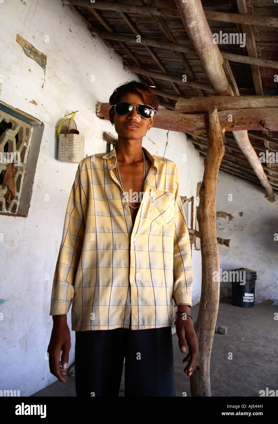 Young Harijan tribal man wearing aviator sunglasses posing at Bhirandiara Village, Kutch District, Gujarat, India Stock Photo