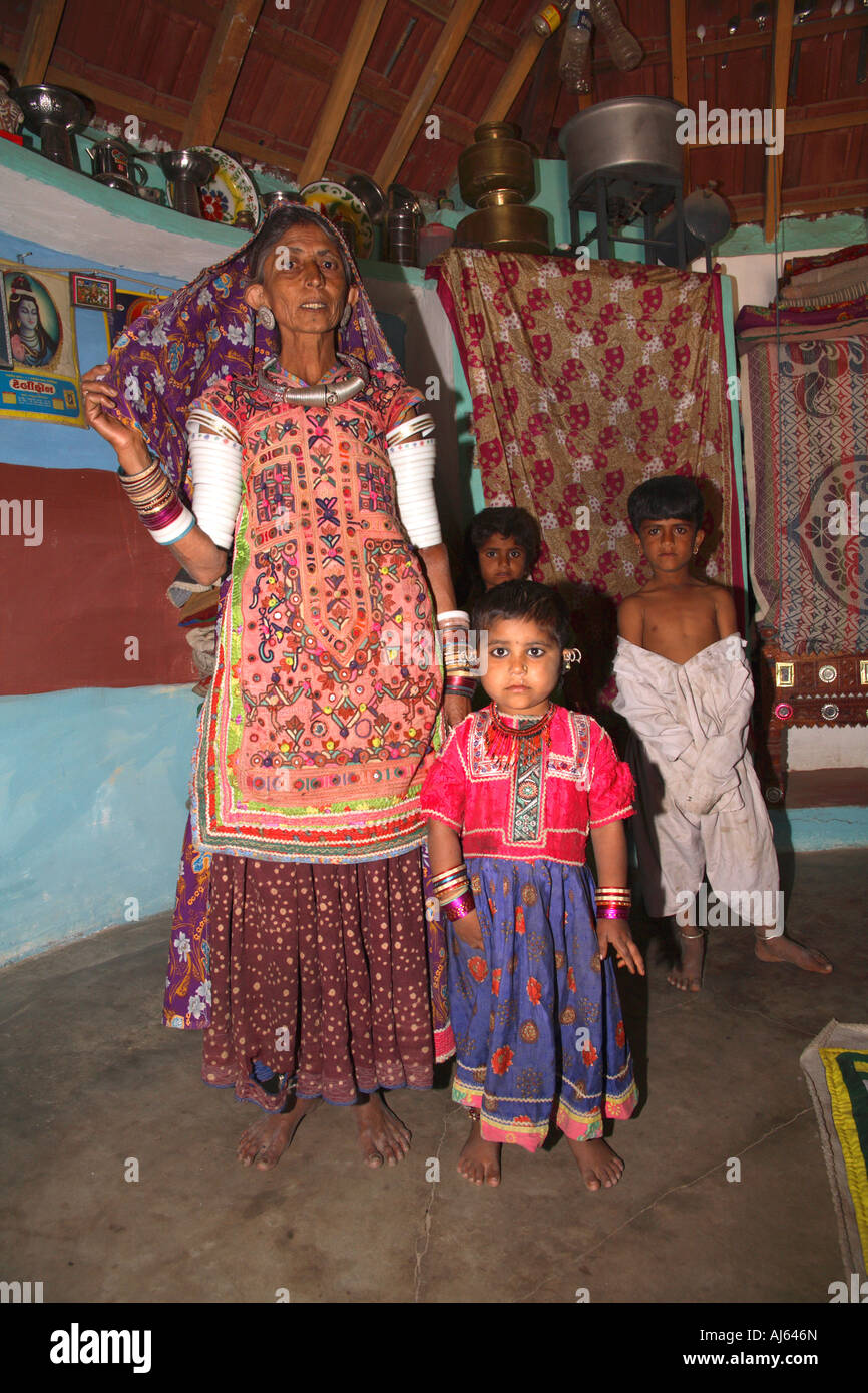 Harijan tribal female with young children in their bhungas mud hut, Bhirendiara Village, Kutch District, Gujarat, India Stock Photo