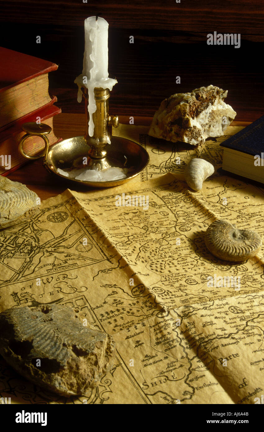Fossils old map books and candle stick Stock Photo