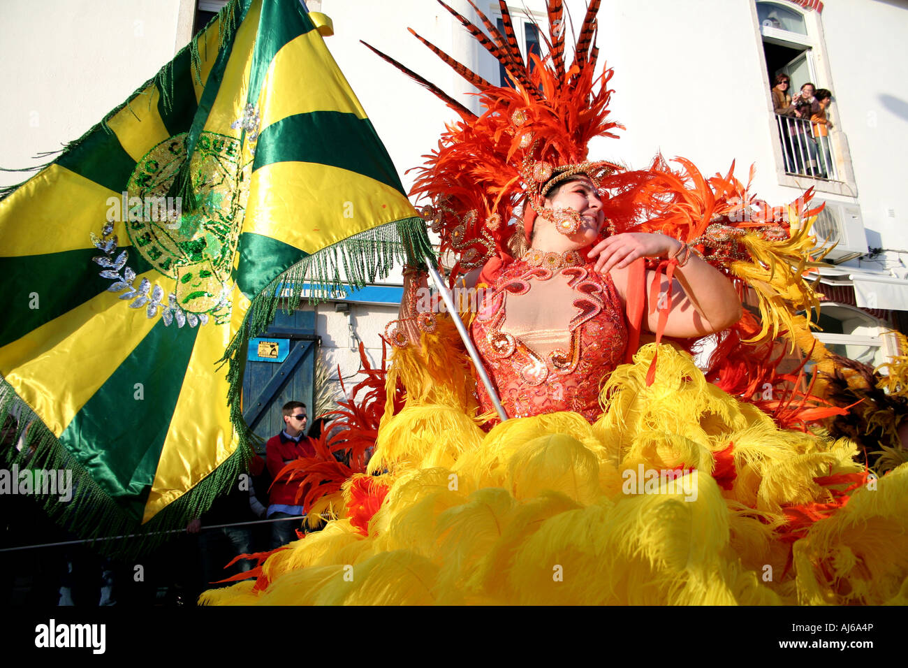 “Porta Bandeira” (flag carrier) character, exhibiting the flag of a Brazilian Samba School, in the Sesimbra Carnival (Portugal) Stock Photo
