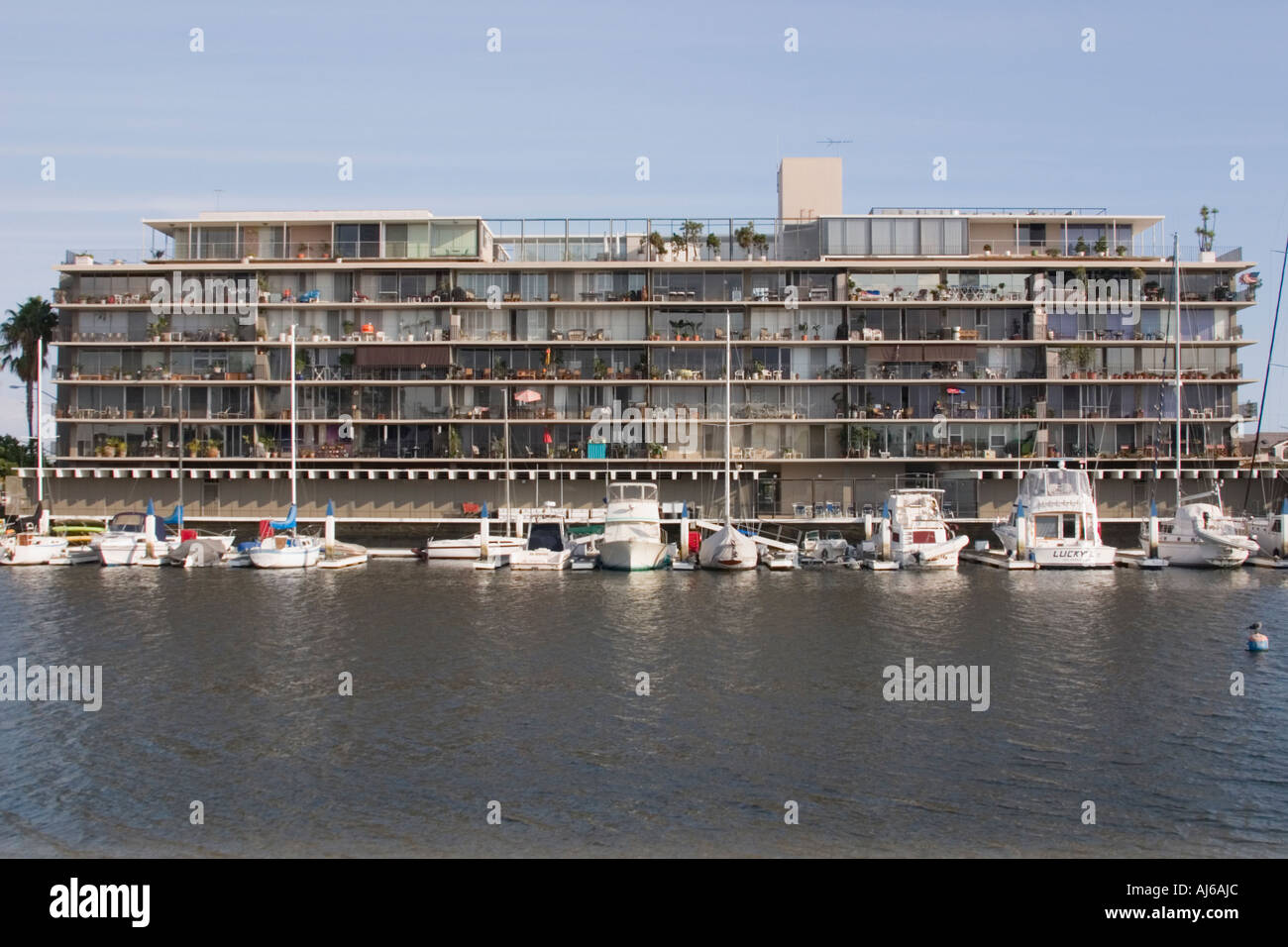 Residential condominium building ("Portofino Building") and boat docks, Naples Island, Alamitos Bay, Long Beach, California, USA Stock Photo
