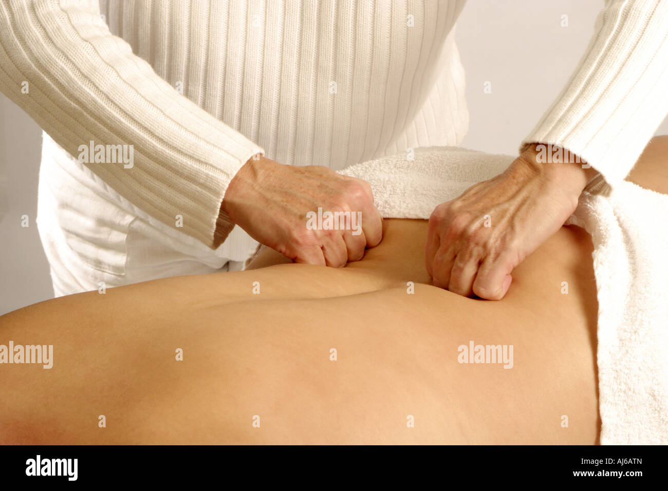 massaging a woman's back Stock Photo