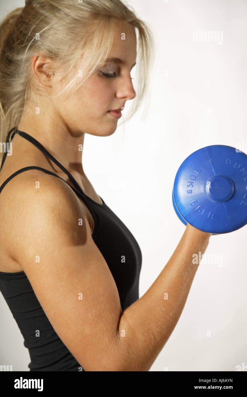 young woman with dumb bell Stock Photo