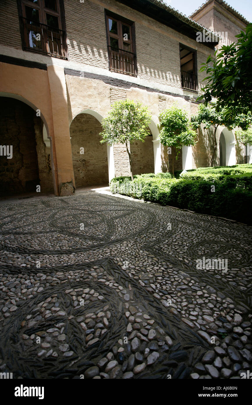 A patterned stone walkway inside La Alhambra in Granada s old section Stock Photo