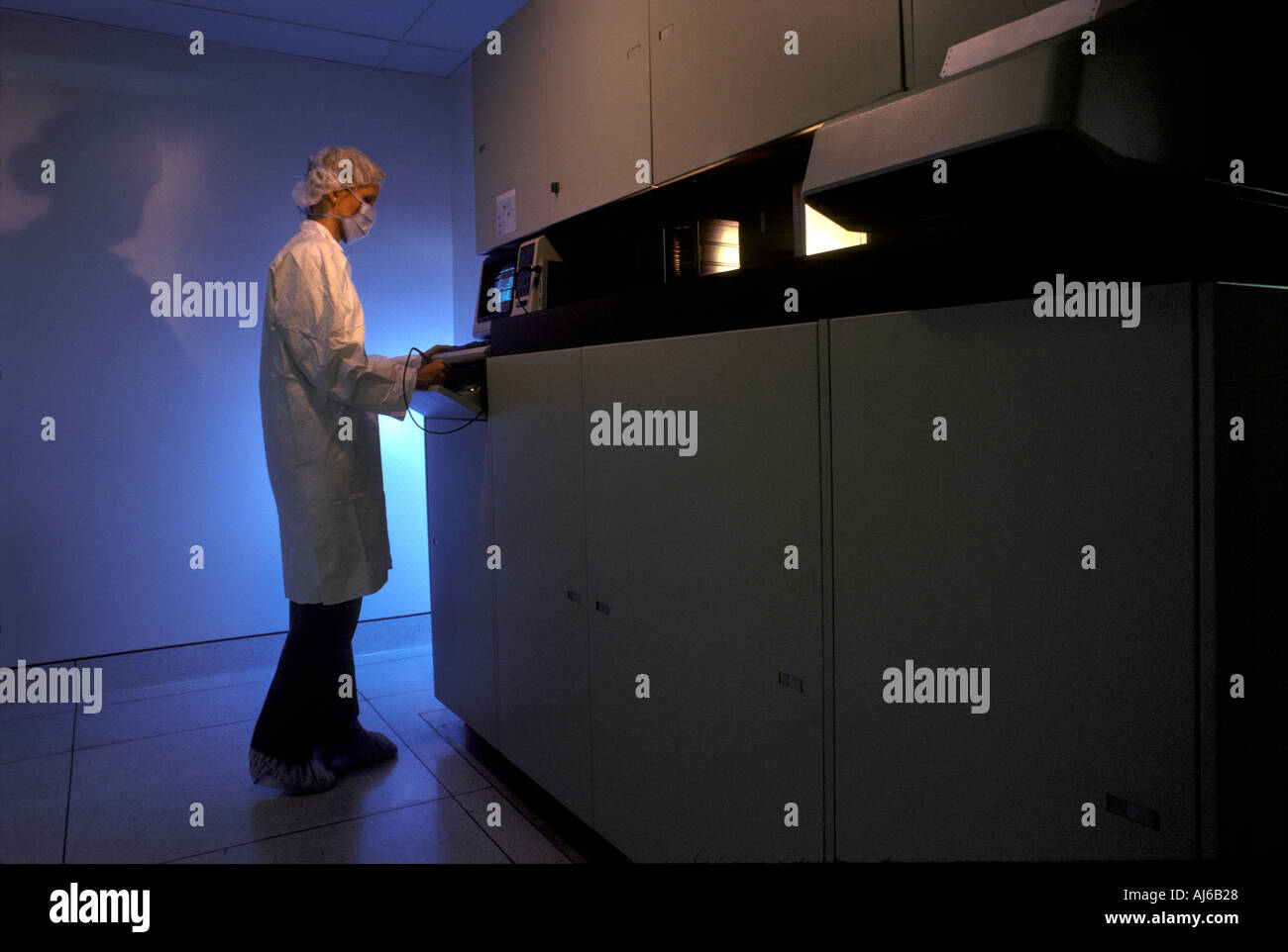 Worker In Clean Room Loading Computer Chip Manufacturing