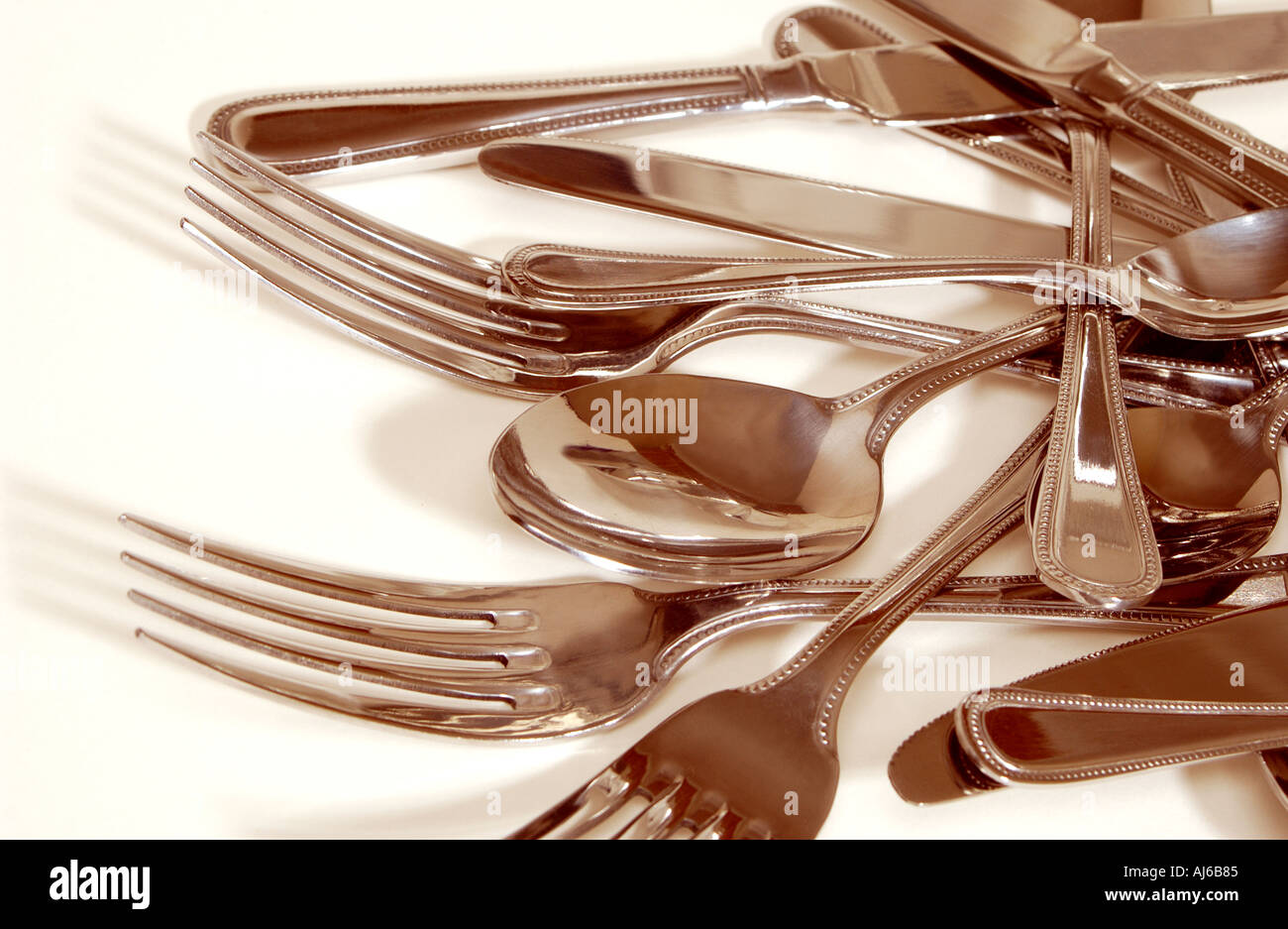 Knives spoons and forks pile of silver cutlery Stock Photo
