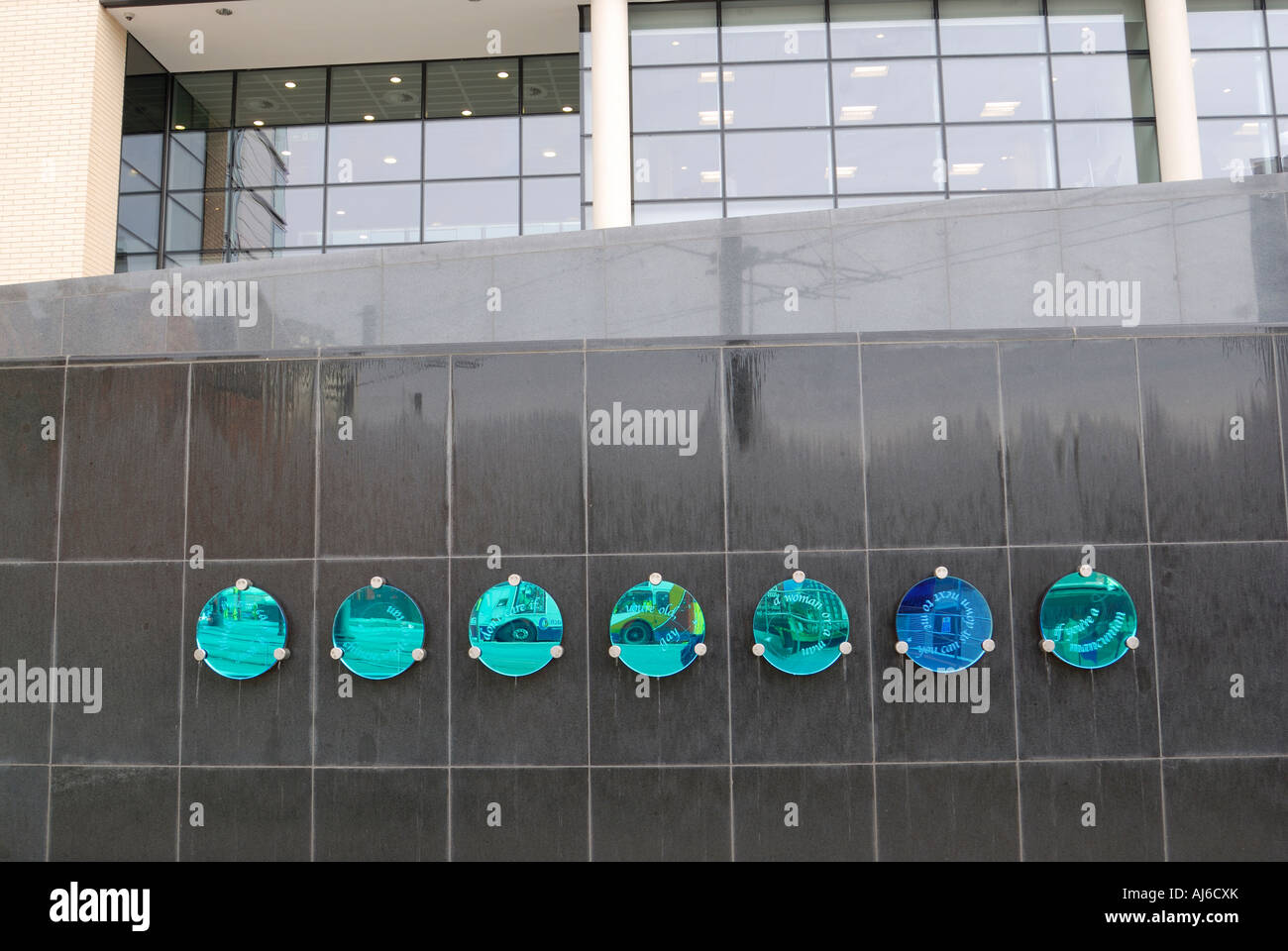 Coloured circular mirrors on a wall in Manchester Stock Photo
