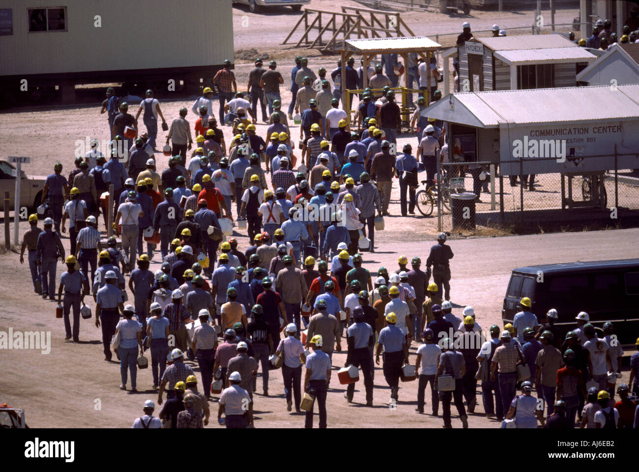 Large group of workers in hard hats leaving work Stock Photo - Alamy