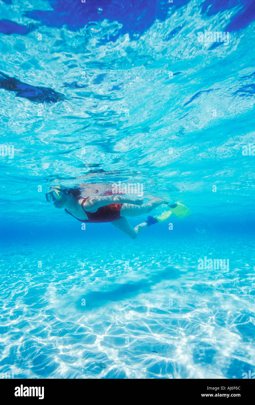 Woman snorkeling in shallow water near Bandos Island in Maldives Indian