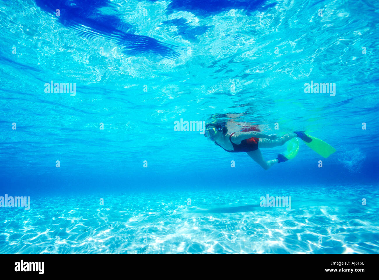 Woman snorkeling in shallow water near Bandos Island in Maldives Indian