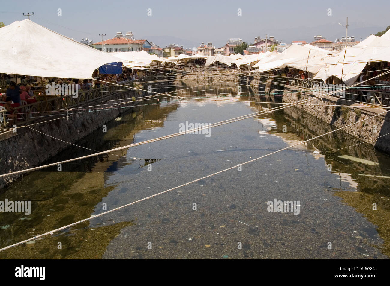 The traditional tented market at Fethiye Turkey the tents reflected in the canal  Stock Photo