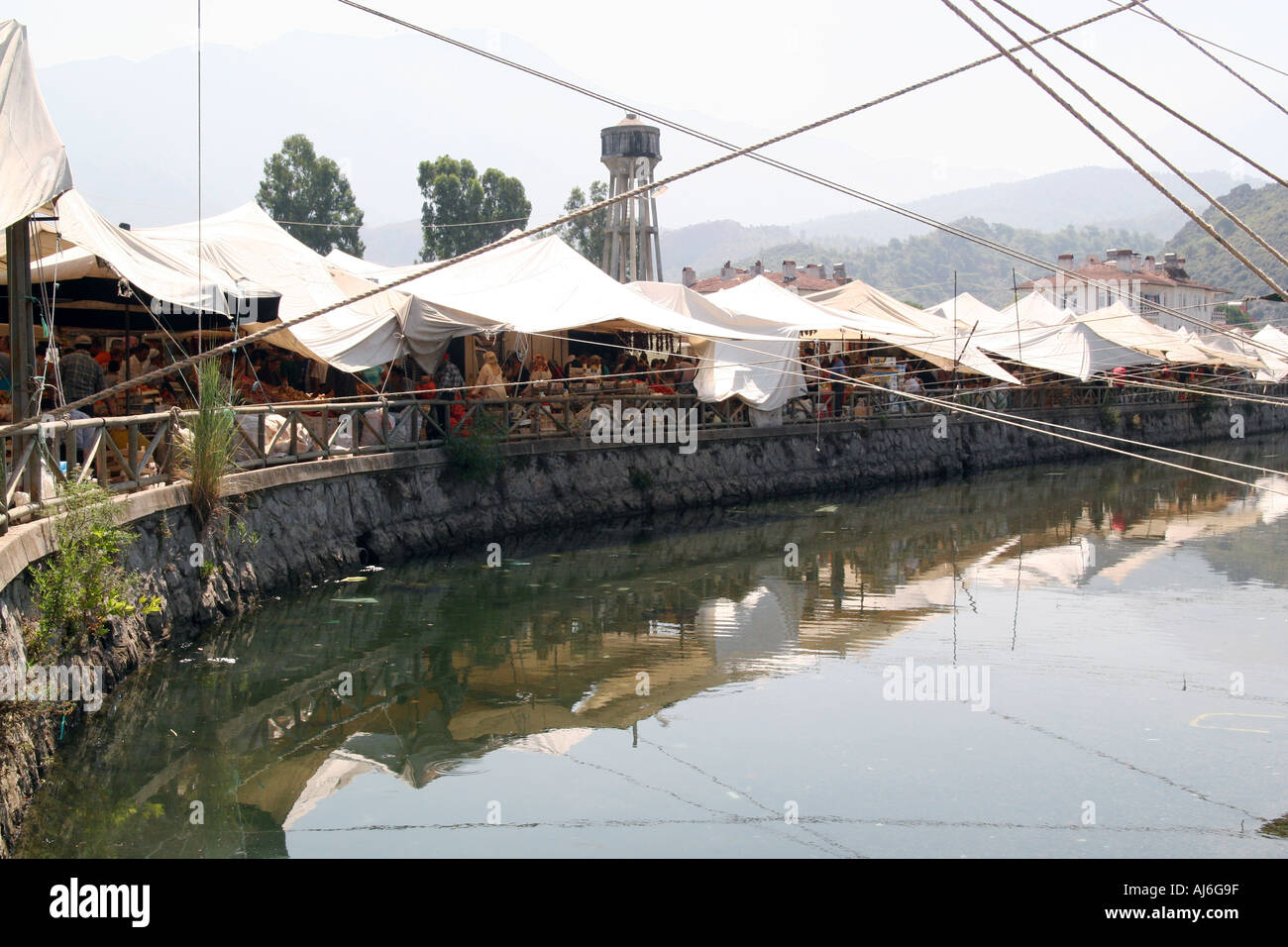 The traditional tented market at Fethiye Turkey the tents reflected in the canal  Stock Photo