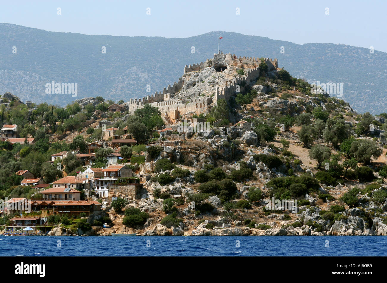 The village of Kale Anatolia southern Turkey with its medieval castle beyond  Stock Photo