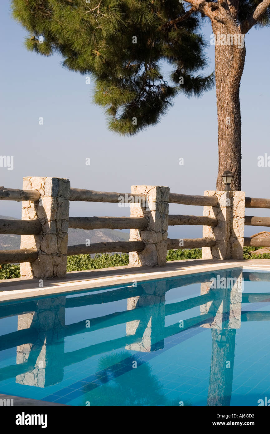 Tranquil scene of a swimming pool with a pine tree beyond southern Turkey  Stock Photo