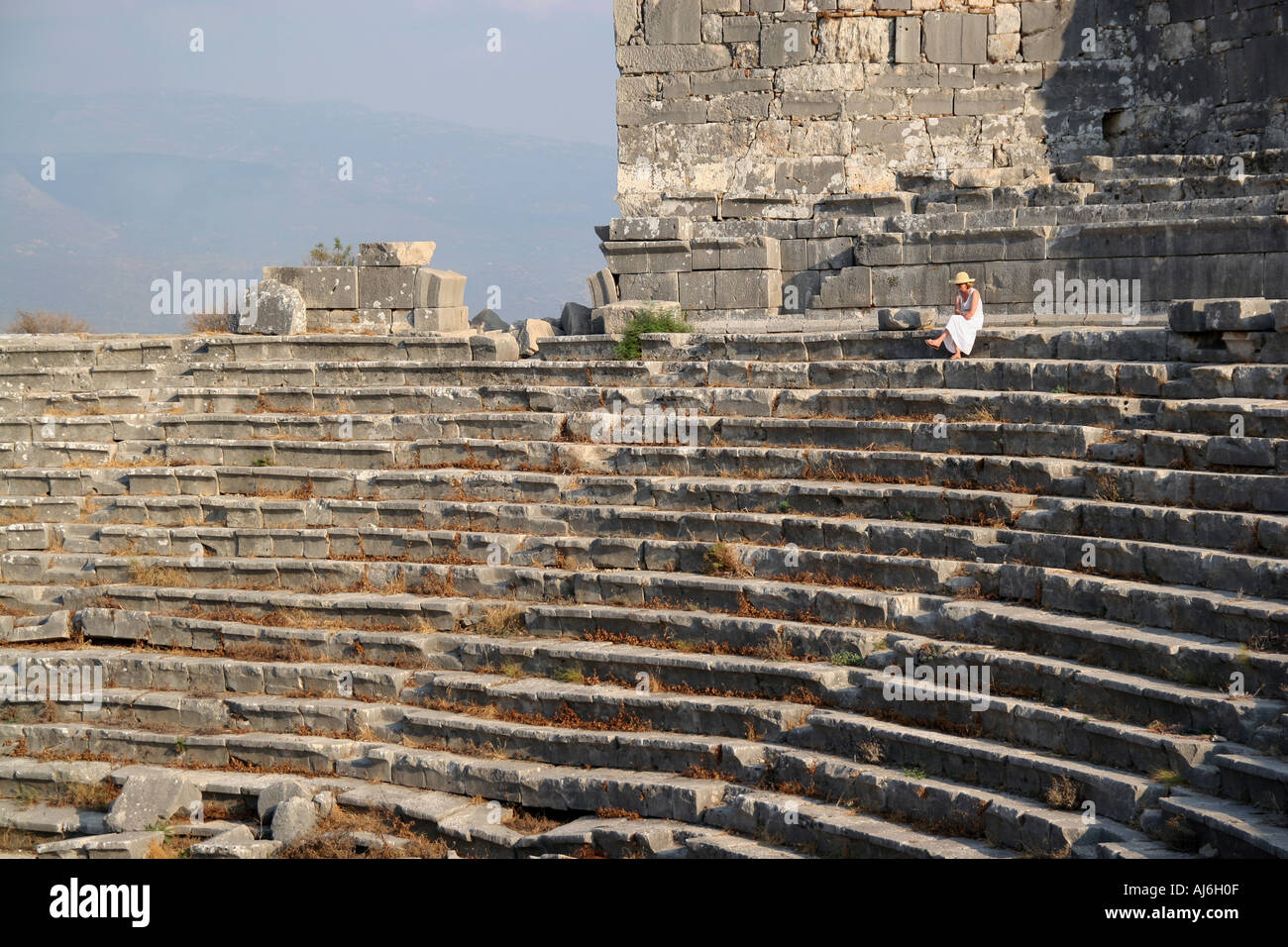The Roman amphitheatre at Xanthos Anatolia southern Turkey observed by elegant lady  Stock Photo