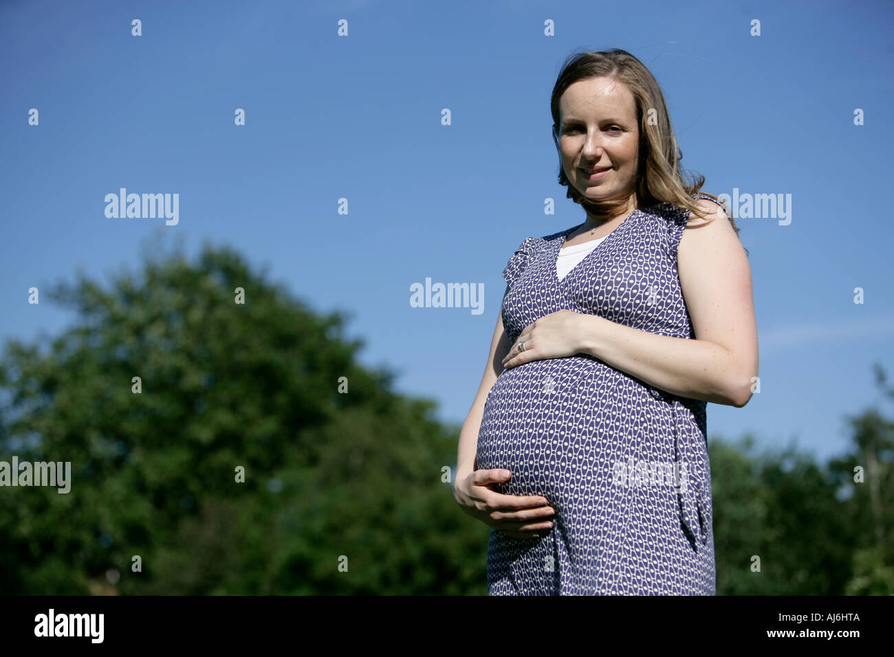 Woman pregnant in a park happy Stock Photo