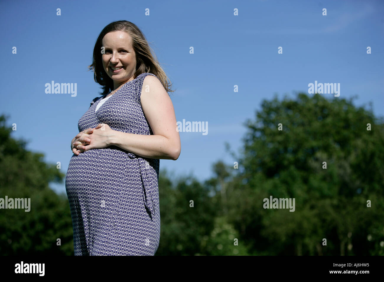 Woman pregnant in a park happy Stock Photo - Alamy