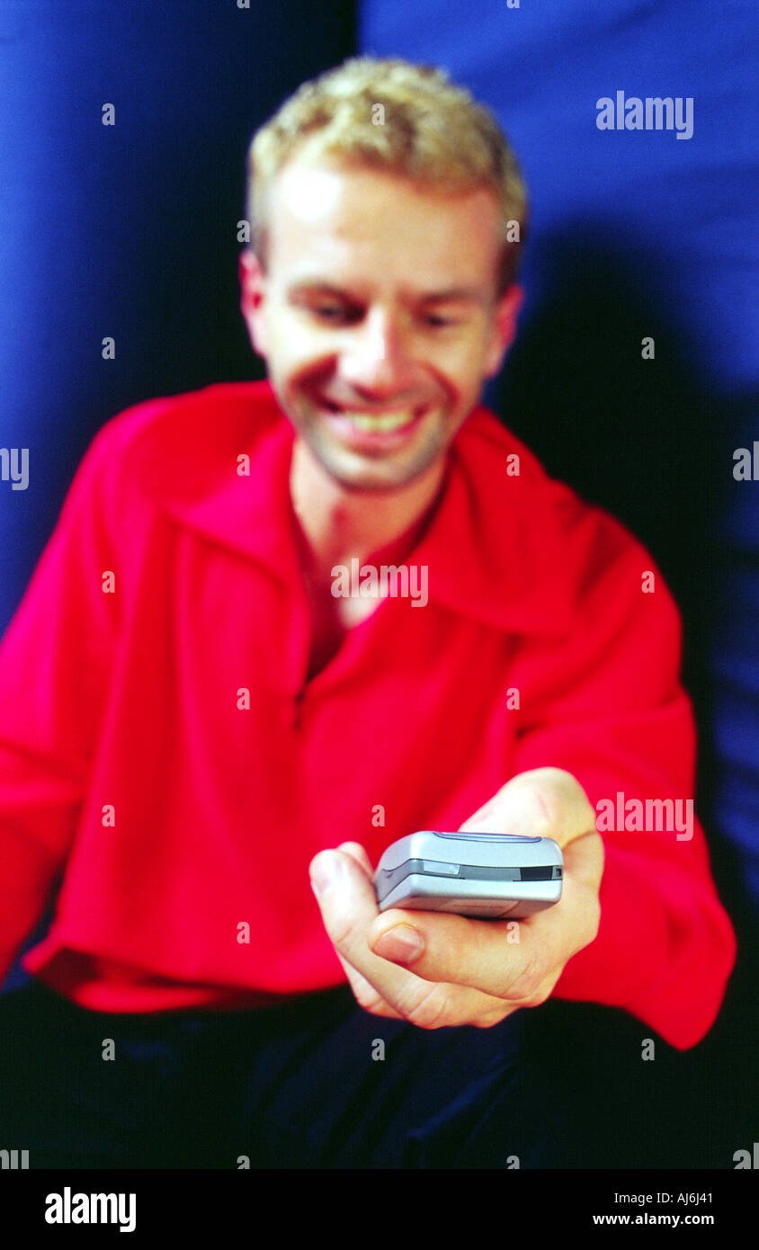 Young man writing an SMS. Stock Photo