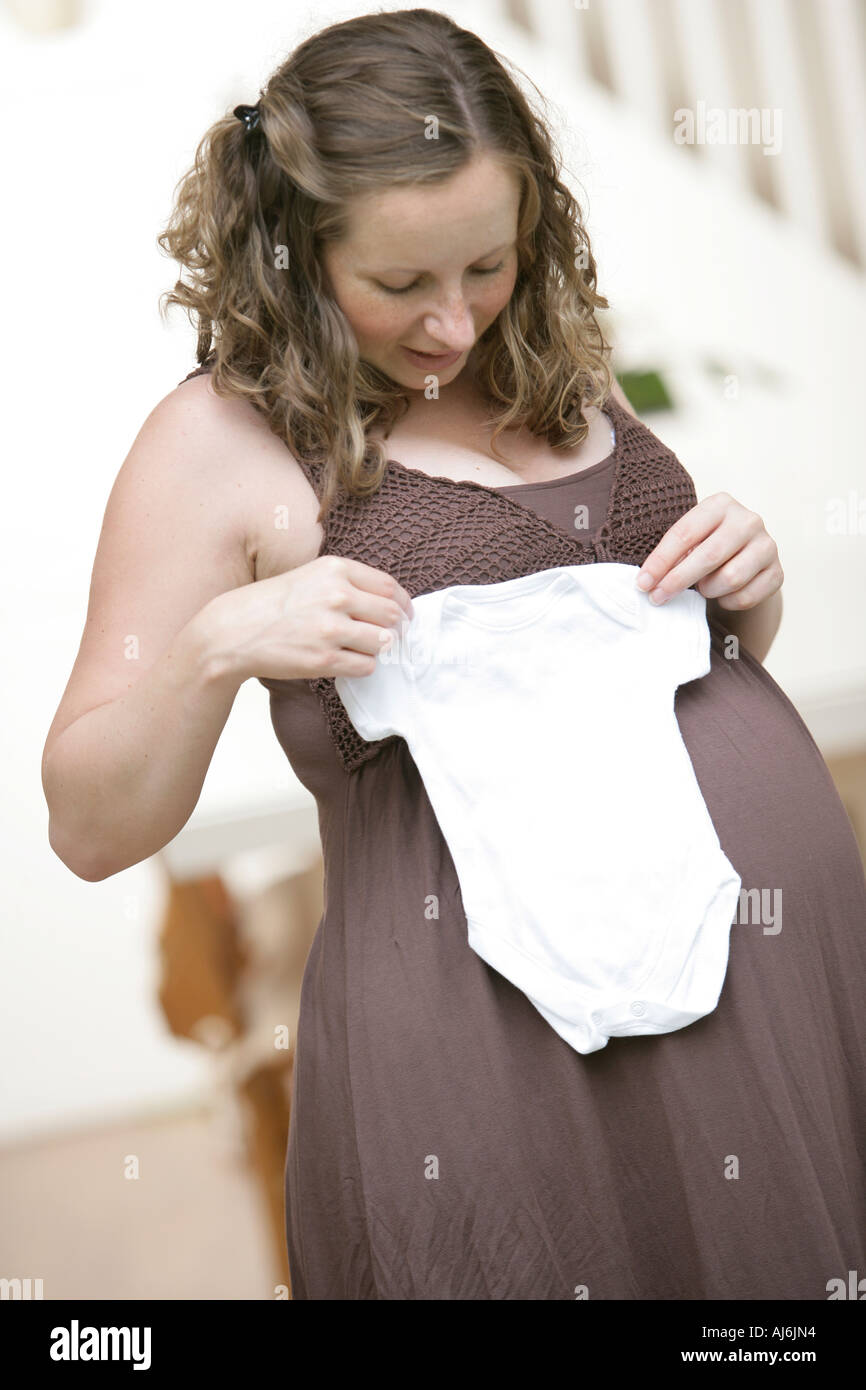 Pregnant woman holding a baby grow Stock Photo