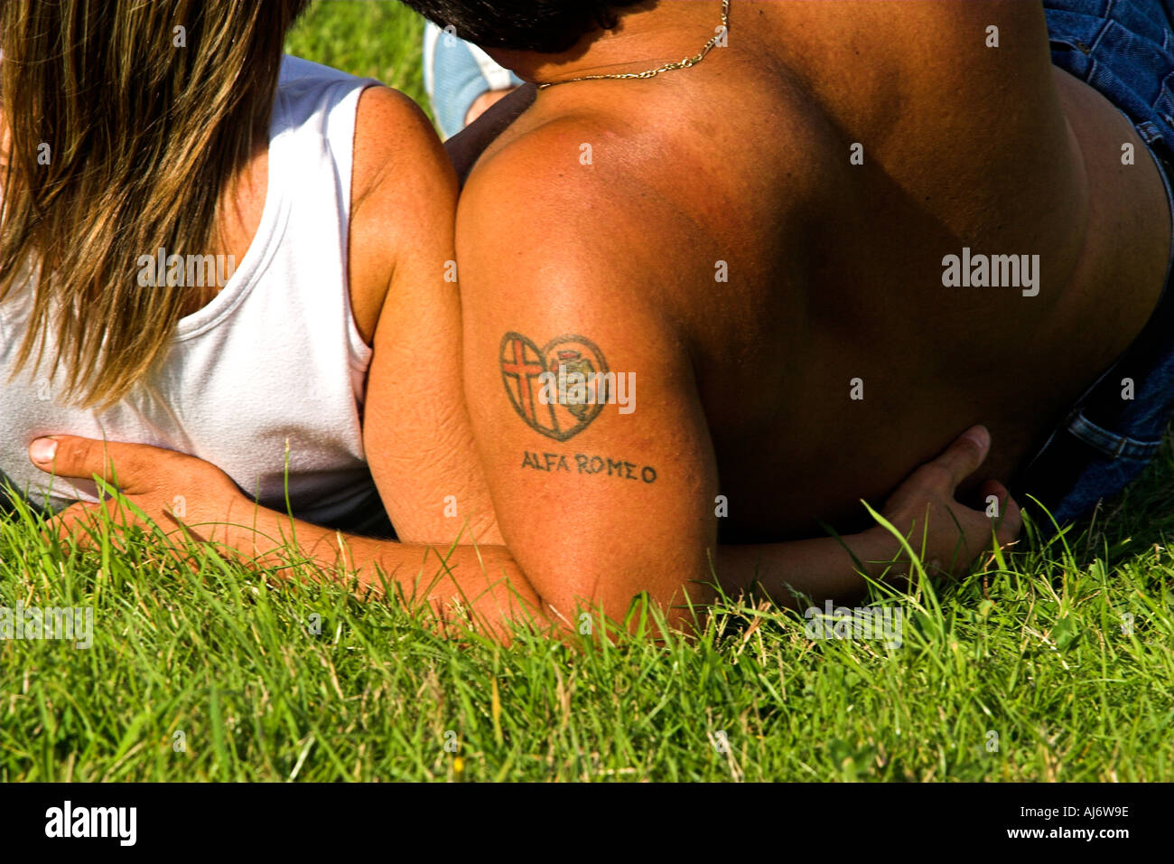 I LOVE ALFA ROMEO A couple lying the grass together. Stock Photo