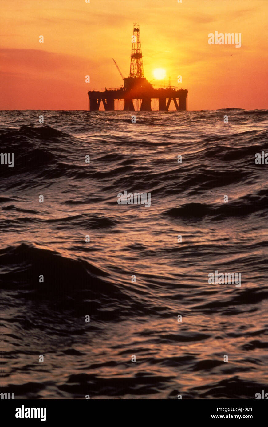 Offshore drilling rig with sunset in North Sea Stock Photo