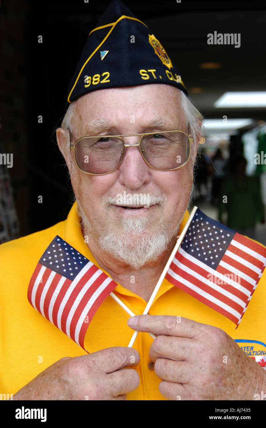 Military Veteran Holds Flags Stock Photo - Alamy