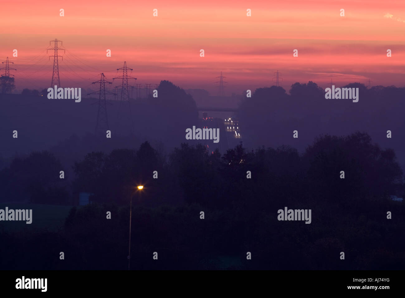 Countryside road pylon field Stock Photo - Alamy