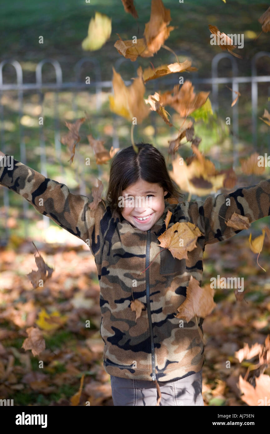 Girl Playing in Autumn Leaves Stock Photo - Alamy
