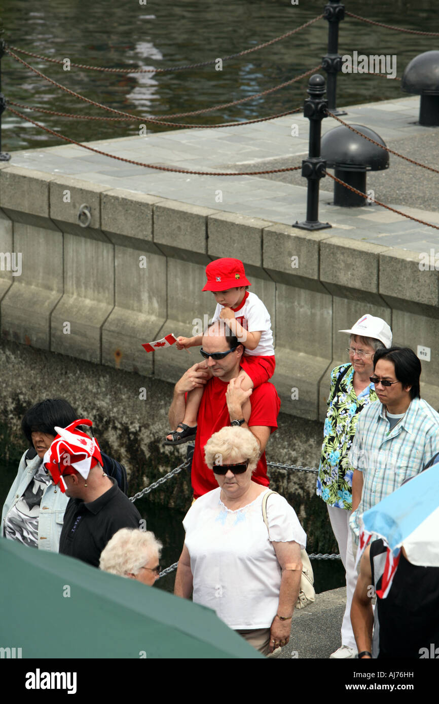 A boy riding on his farther s shoulders in downtown Victoria during ...