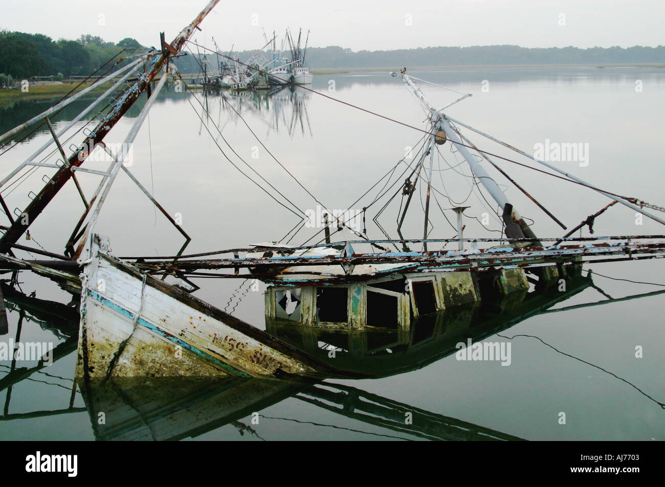 A sunken and abandoned shrimp boat awaits salvage in a watery resting ...