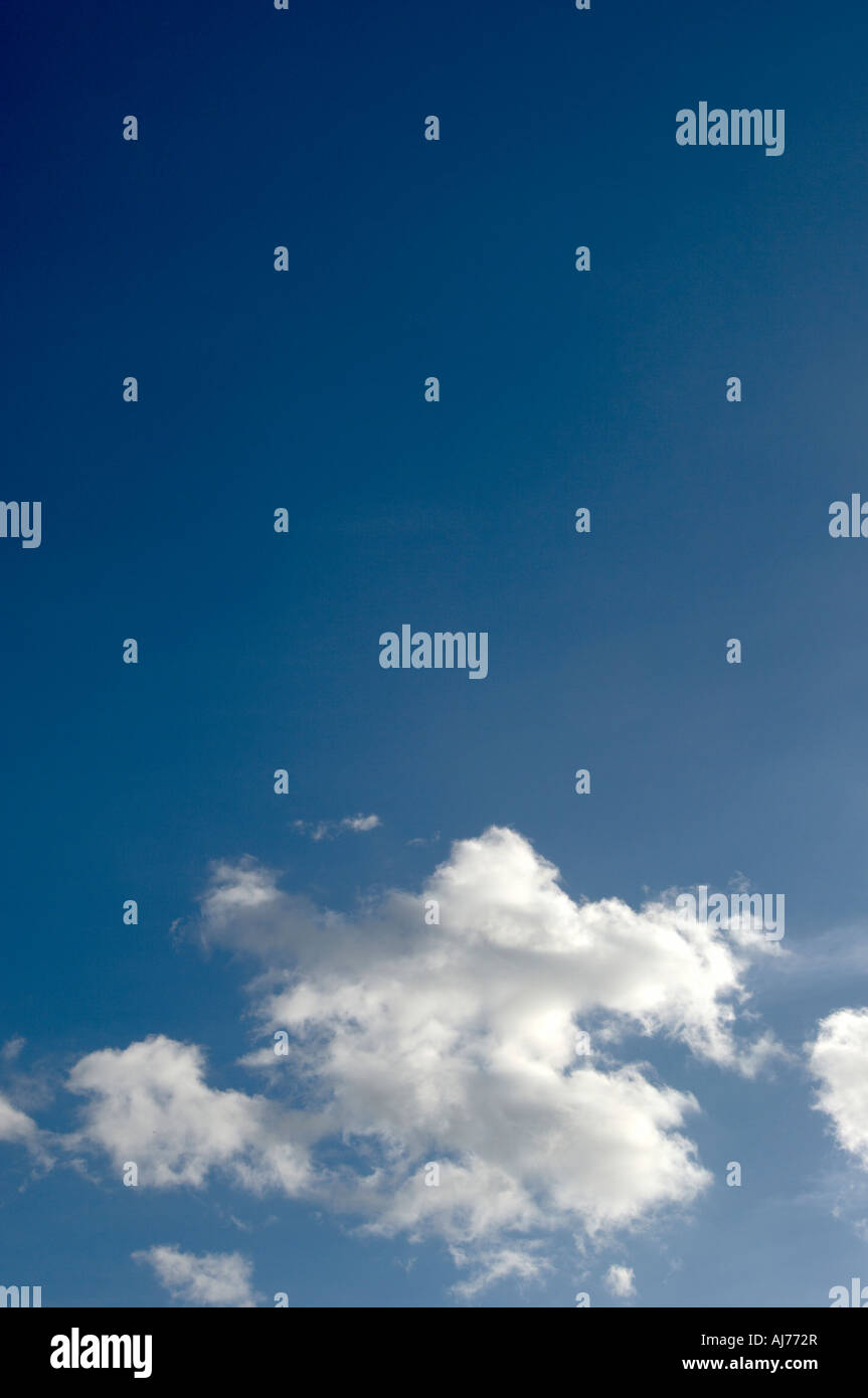 Bright sunny blue sky with fluffy clouds Stock Photo - Alamy