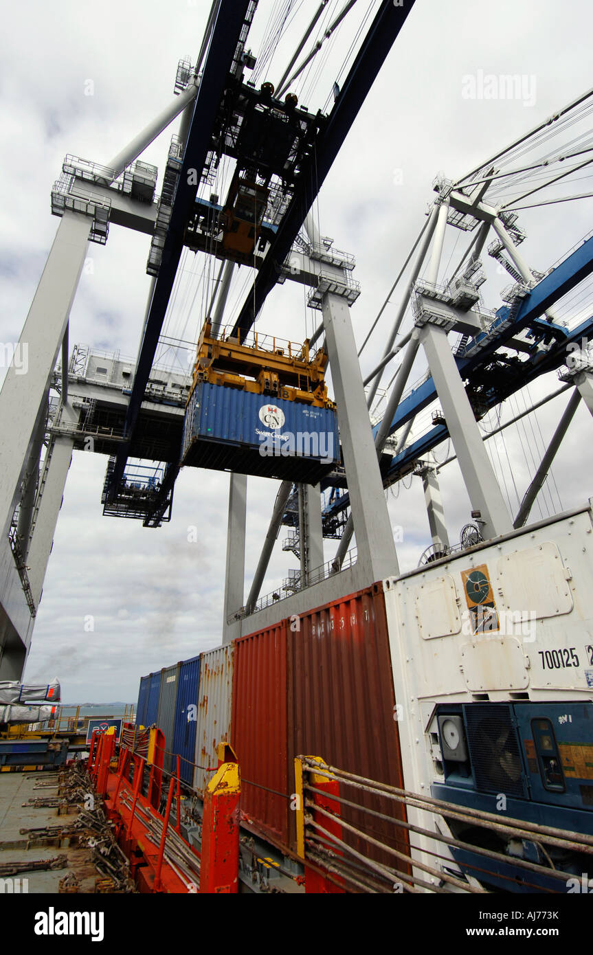 Shipping containers being loaded on to the deck of a container ship by ...