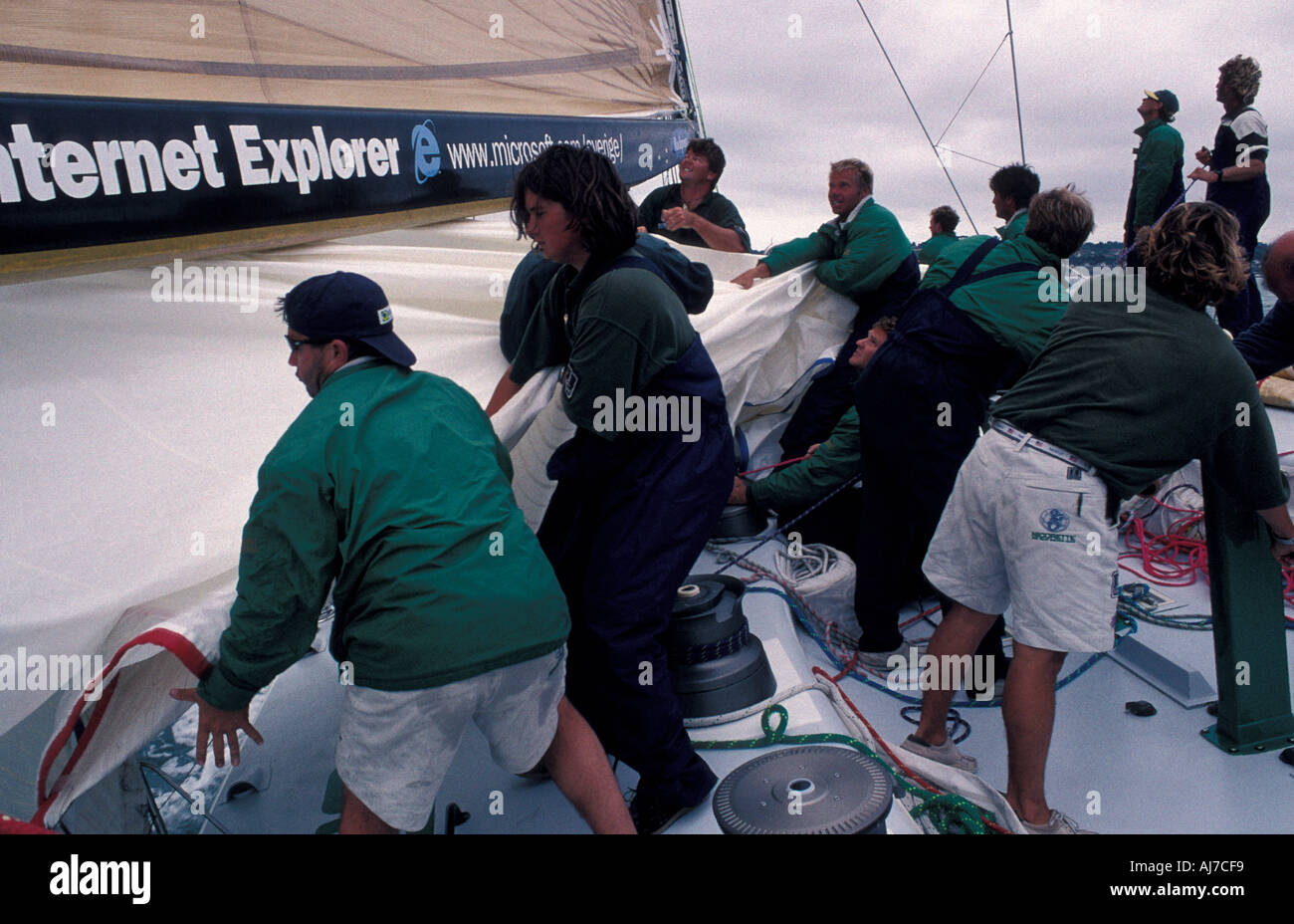 Maxi yacht Nicorette action on deck hauling in a sail English Channel  England Great Britain UK Stock Photo