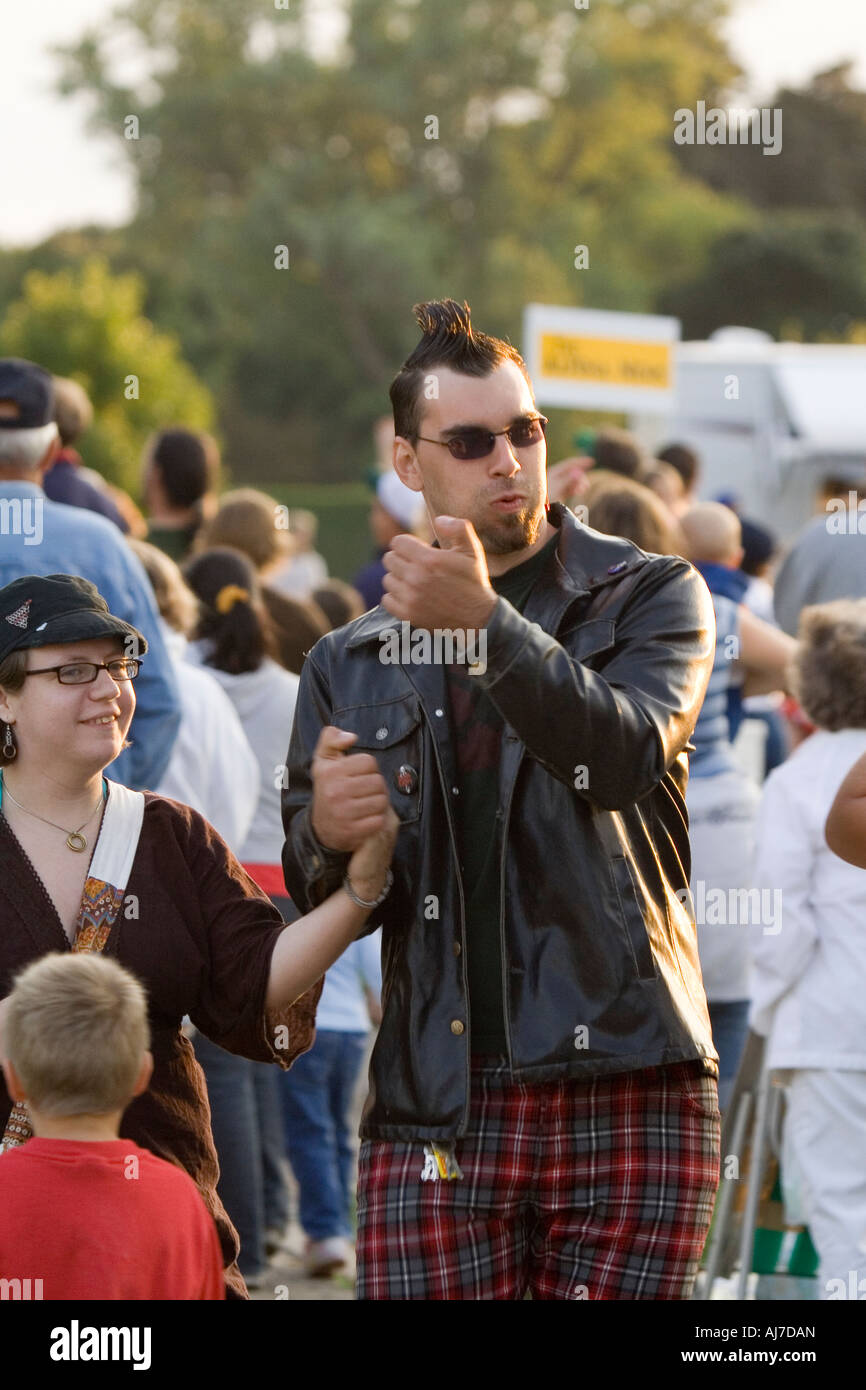 Punk couple walking through crowd Stock Photo