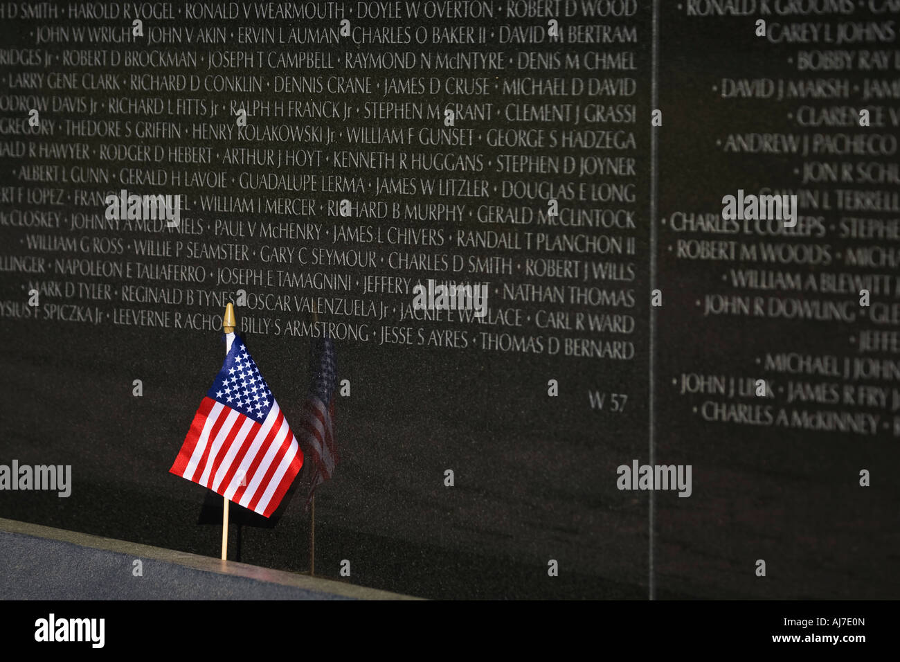 American flag propped against the Wall of the Vietnam Veterans Memorial, Washington DC. Stock Photo