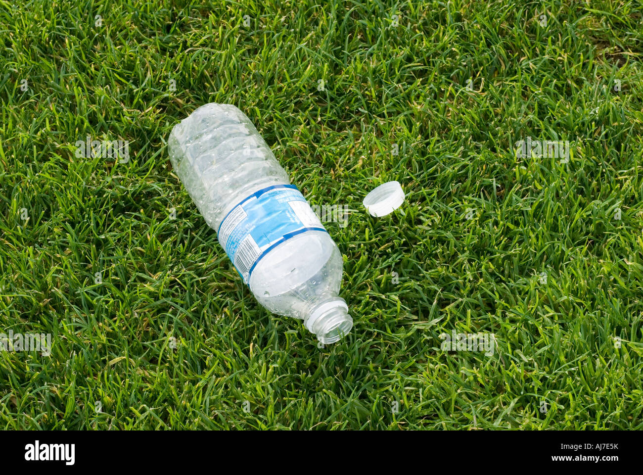 Discarded empty water bottle on grass Stock Photo
