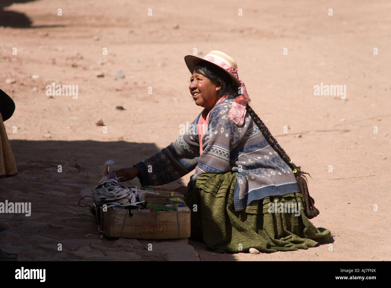 Indian woman selling in a town on the road from Potosi to the Salar de Uyuni salt flats on the