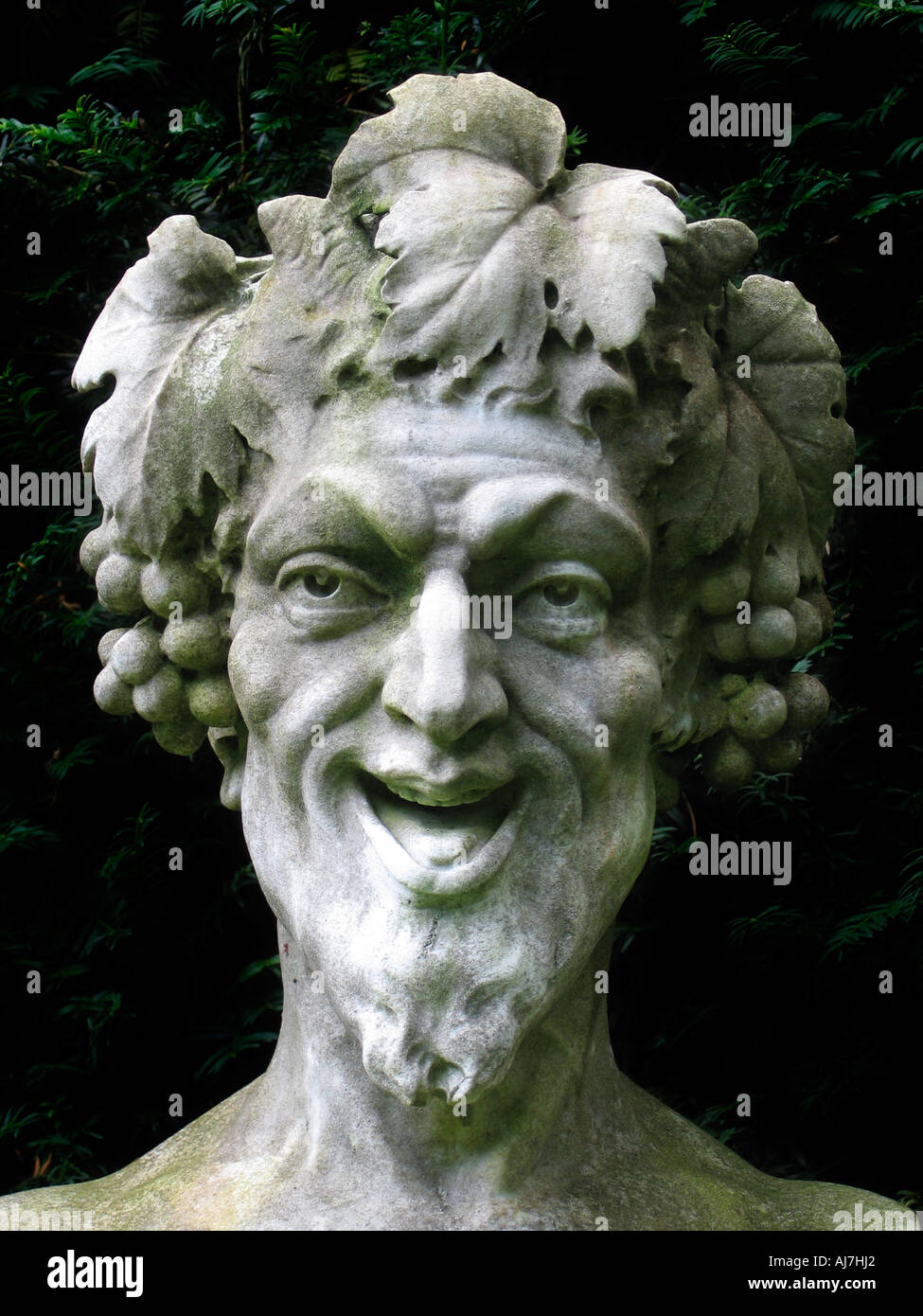 Laughing garden statue with grapes Stock Photo