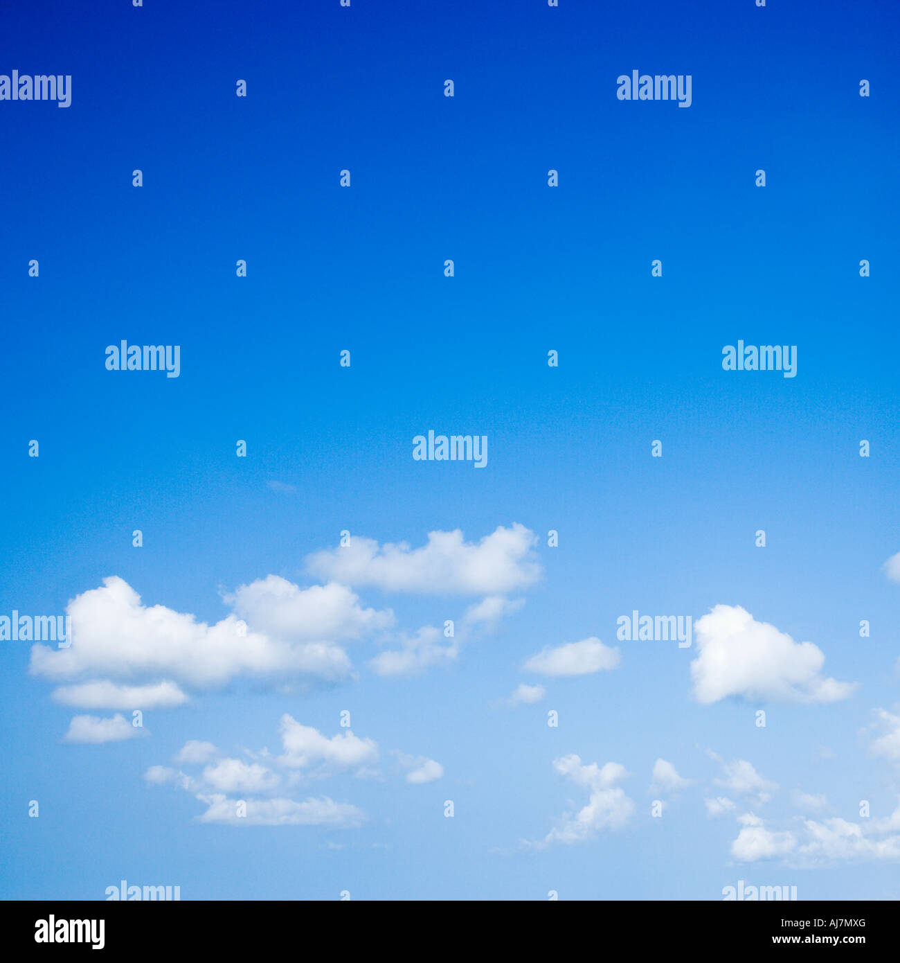 Blue sky with some white puffy clouds Stock Photo - Alamy