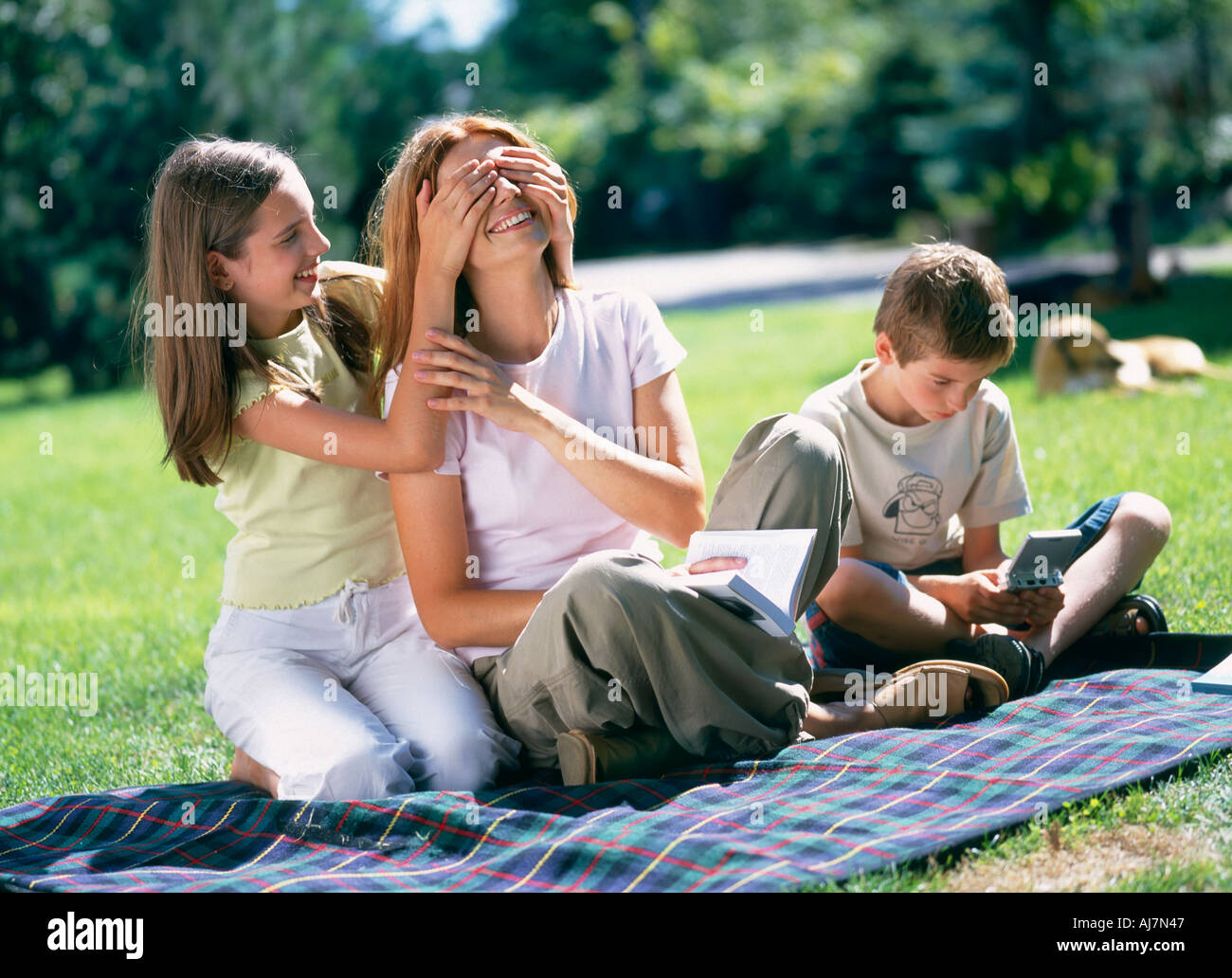 outdoor summer day garden park woman mature mother 35 40 red hair child children boy son Stock Photo