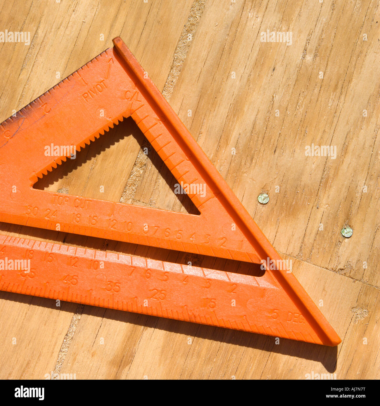 Triangle ruler on unfinished wood Stock Photo - Alamy